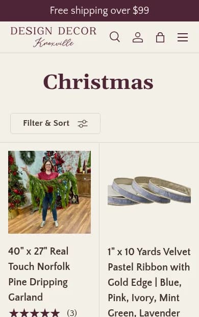 Design Decor Knoxville store on a phone, showing a Christmas collection with a real-touch pine garland.